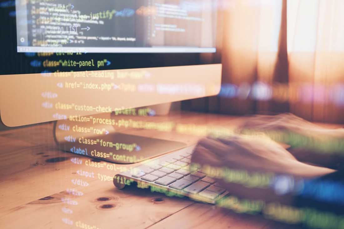 Man on a computer analyzing his insurance company's data using predictive analytics overlayed with a computer program.